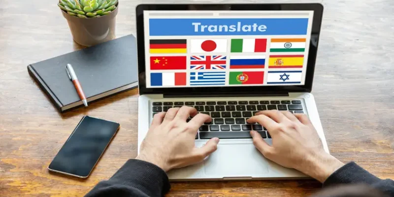 Online translation, foreign languages learning concept. Man working with a computer laptop, translate text on the screen.